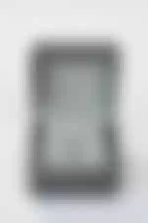 The 18k white gold pendant features a natural blue sapphire with a diamond halo.